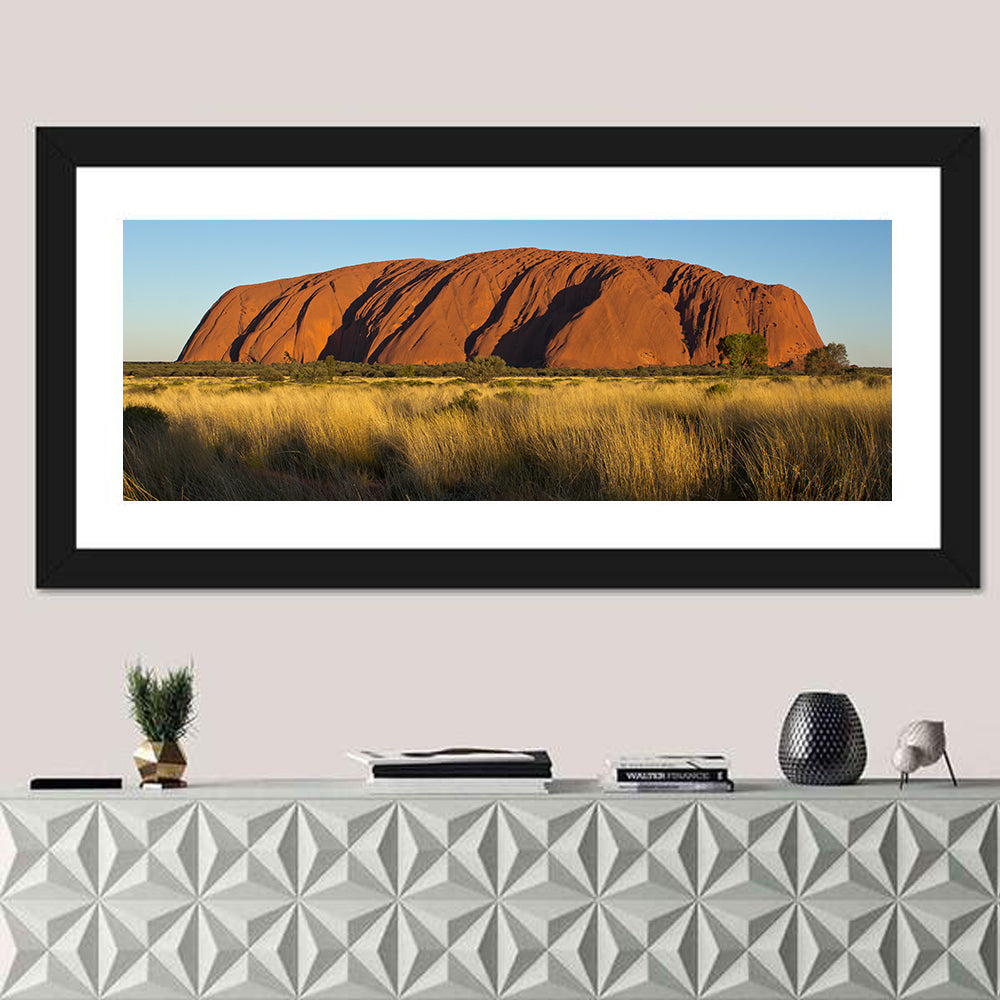 Uluru Red Rock at Golden Hour Wall Art in a room, panoramic