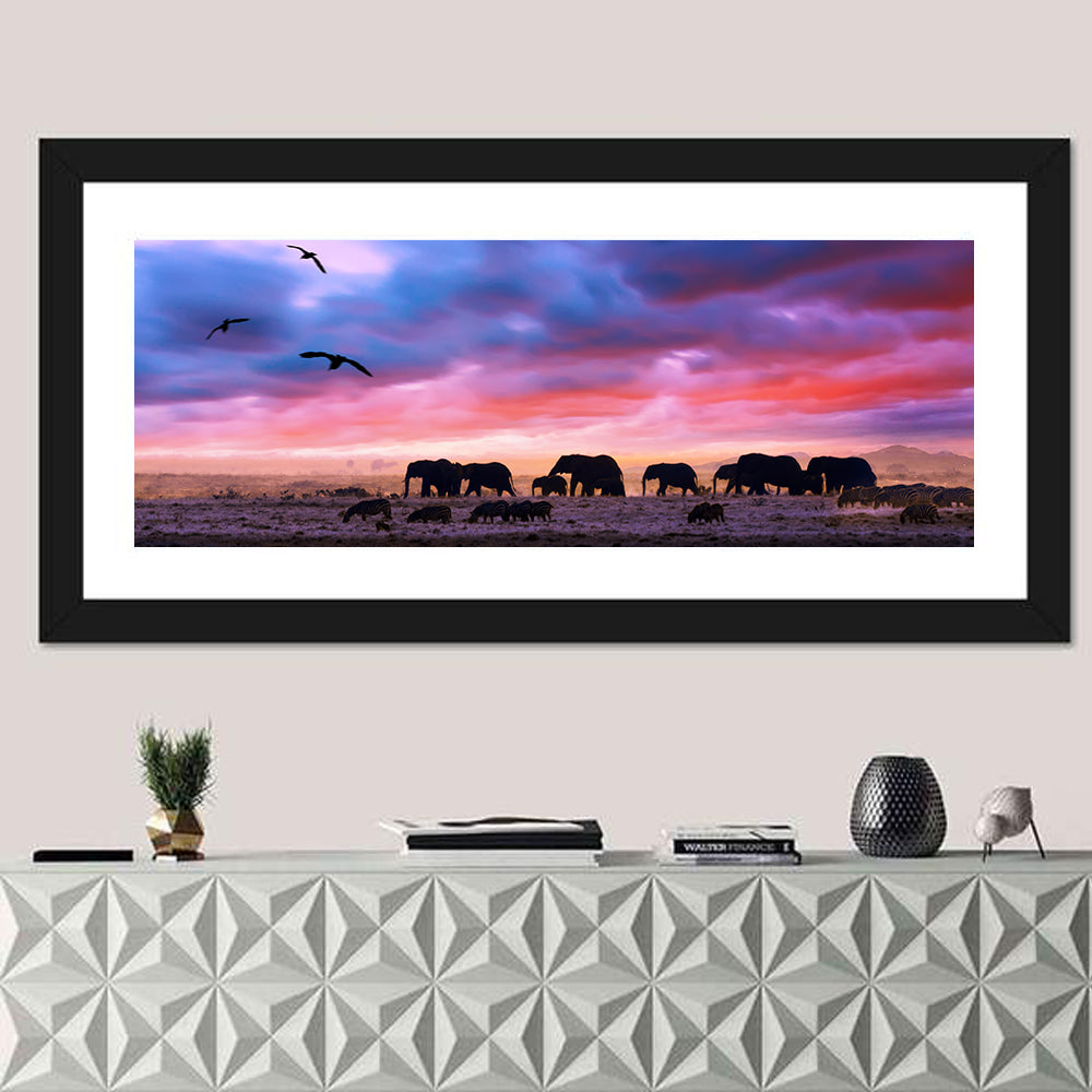 Elephants at Savannah Sunset Wall Art in a room, panoramic