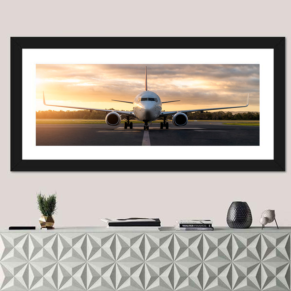 Front Facing Airplane on Runway at Sunset Wall Art in a room, panoramic