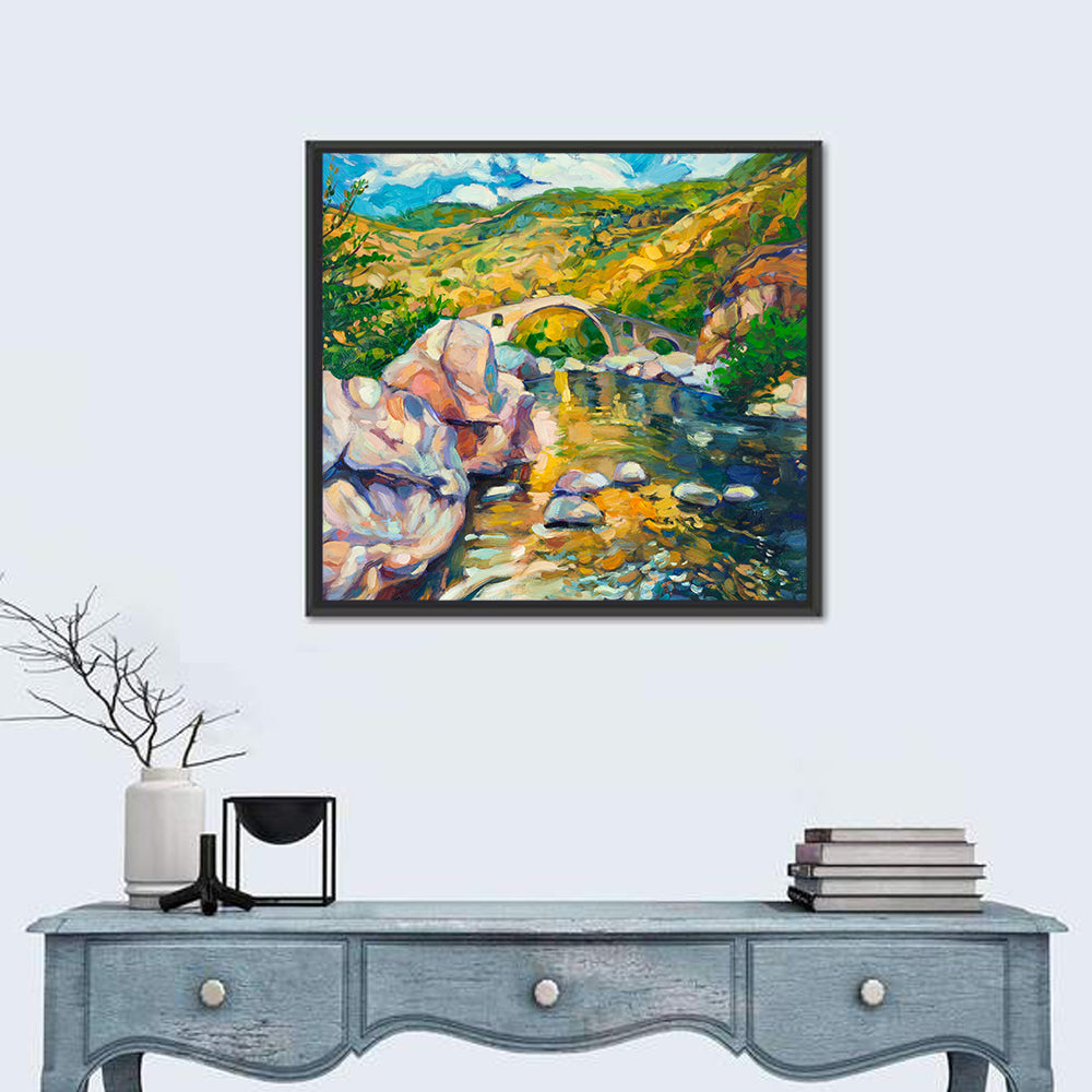 Arched Stone Bridge in Mountain River Wall Art in a room, square