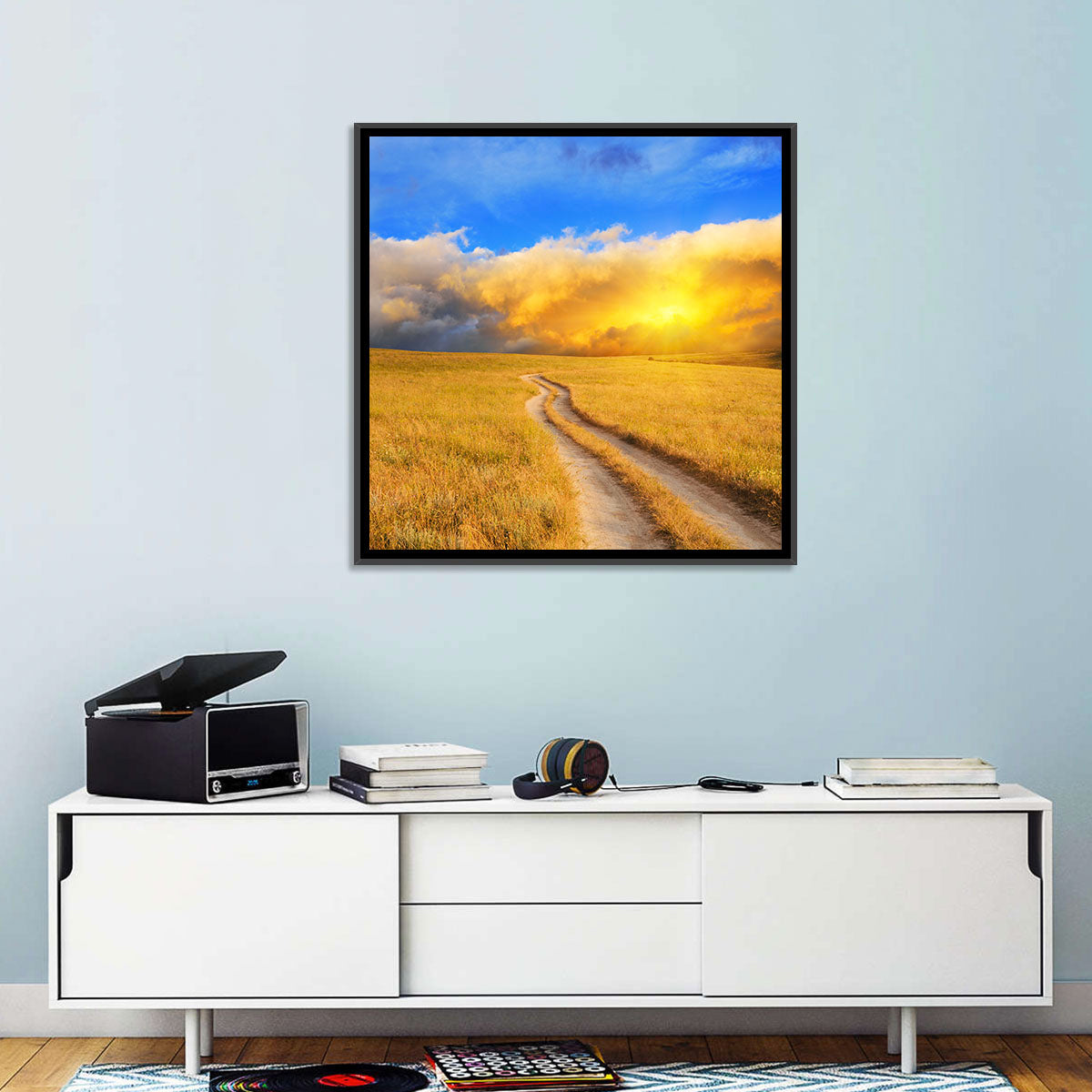 Sunlit Meadow Path with Dramatic Clouds Wall Art in a room, landscape