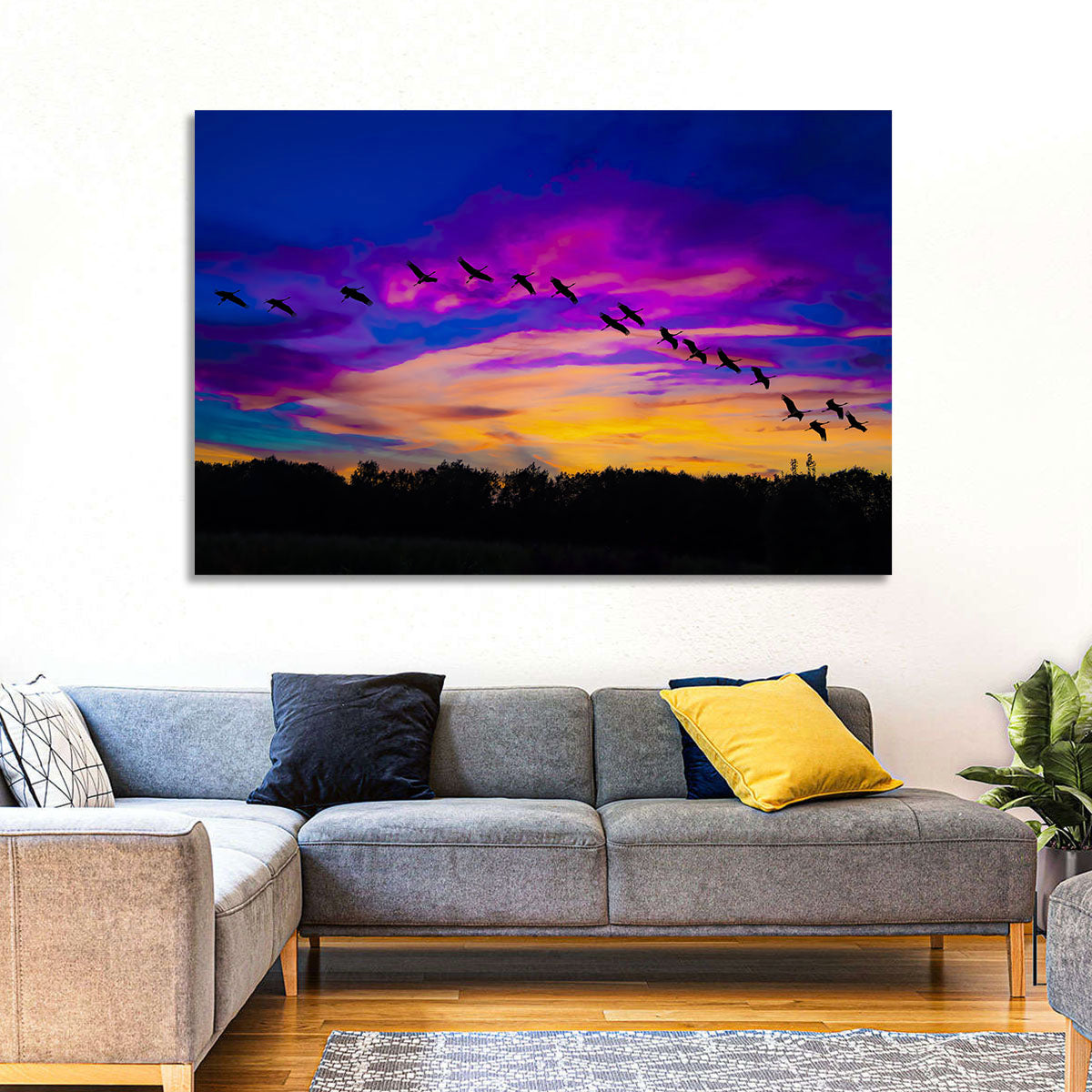 Silhouetted Cranes at Dusk Wall Art in a room, landscape