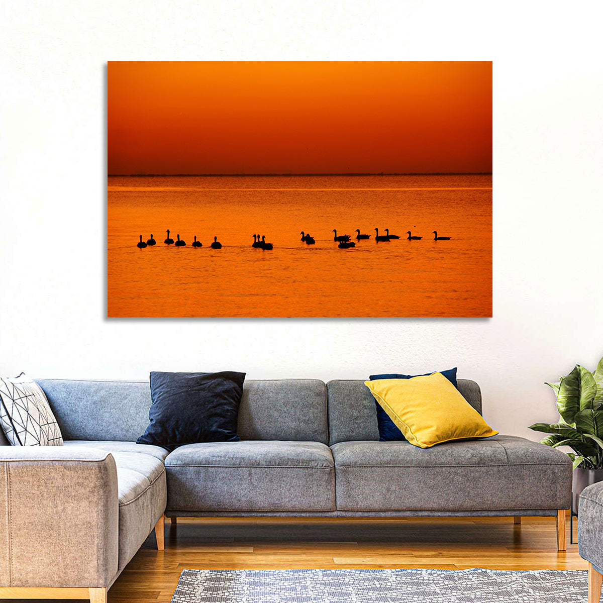 Geese Silhouettes at Orange Sunset Wall Art in a room, landscape