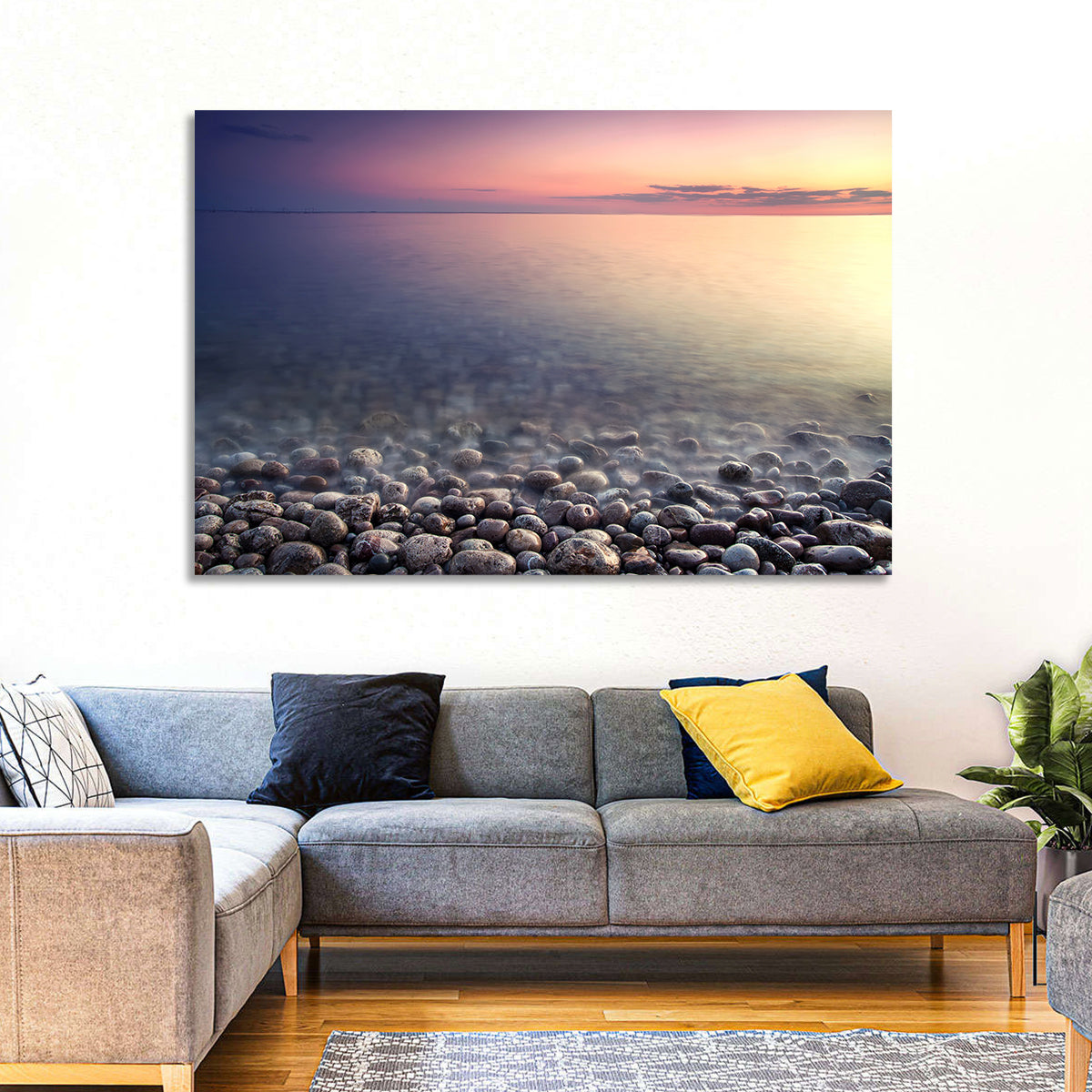 Pebbled Shore Sunset Wall Art in a room, landscape