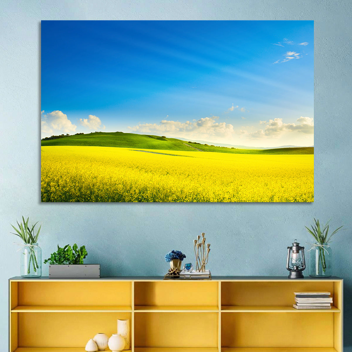 Rapeseed Field and Rolling Hills Under Blue Sky Wall Art in a room, landscape