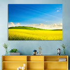 Rapeseed Field and Rolling Hills Under Blue Sky Wall Art