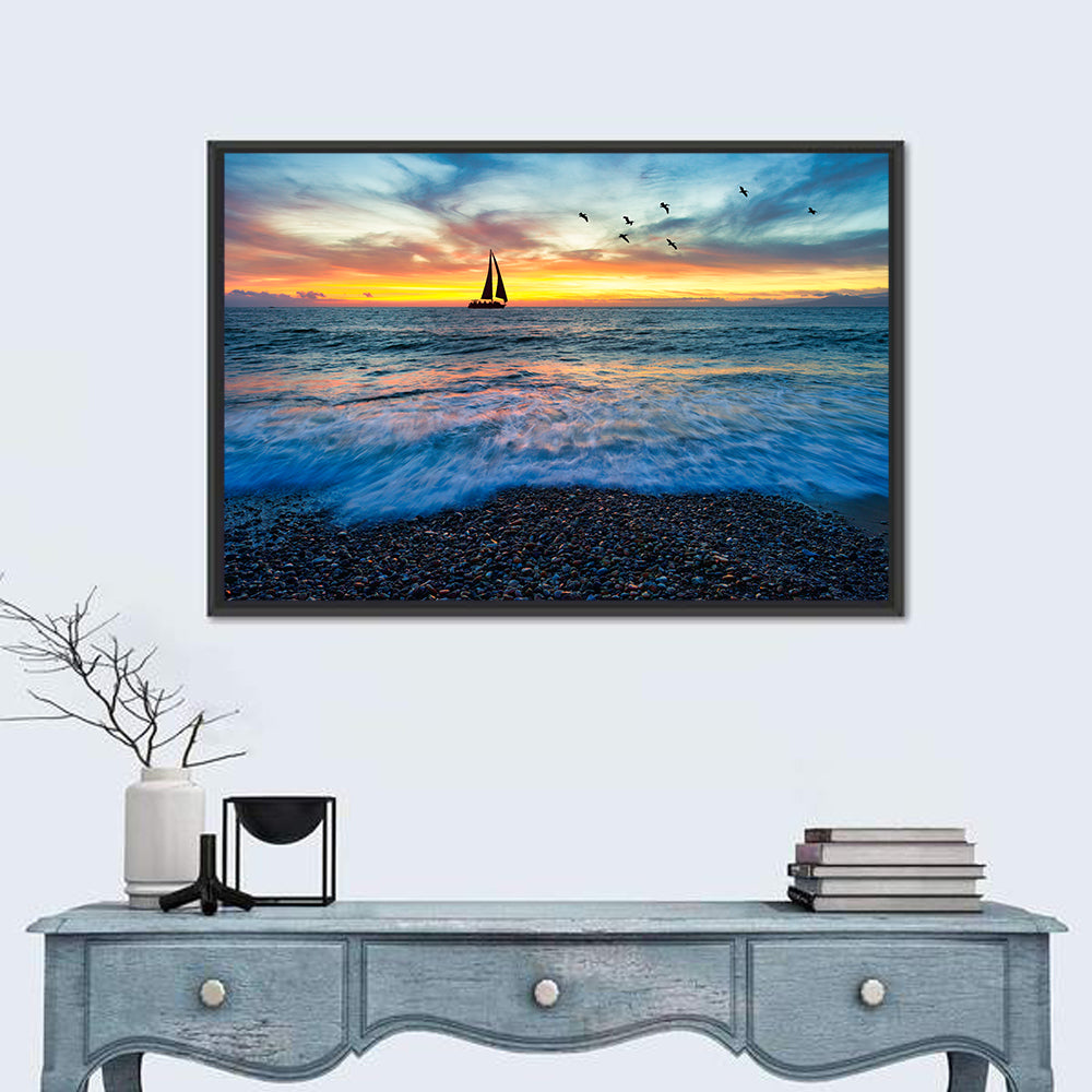 Sunset Sailboat Over Pebble Shore Wall Art