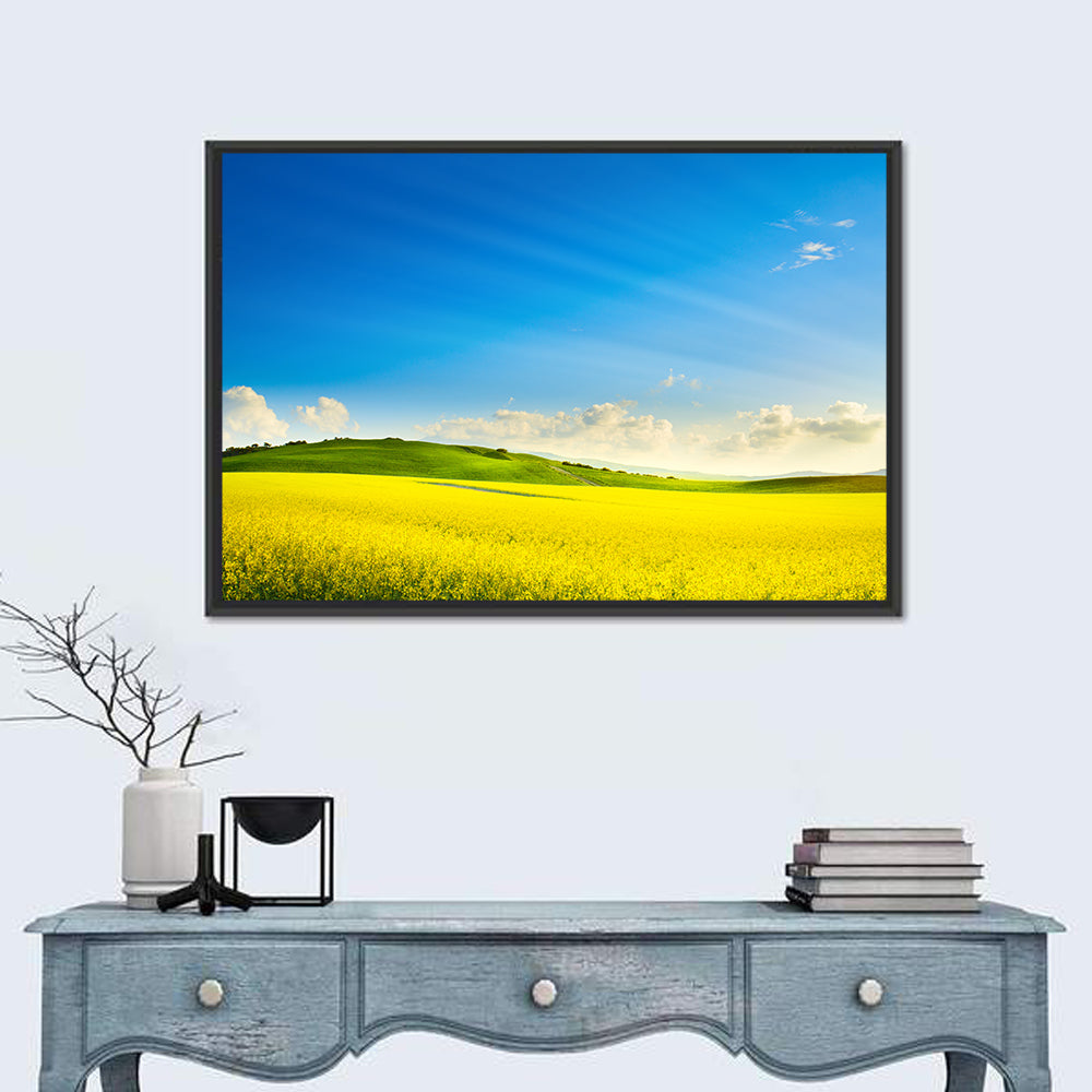 Rapeseed Field and Rolling Hills Under Blue Sky Wall Art in a room, landscape