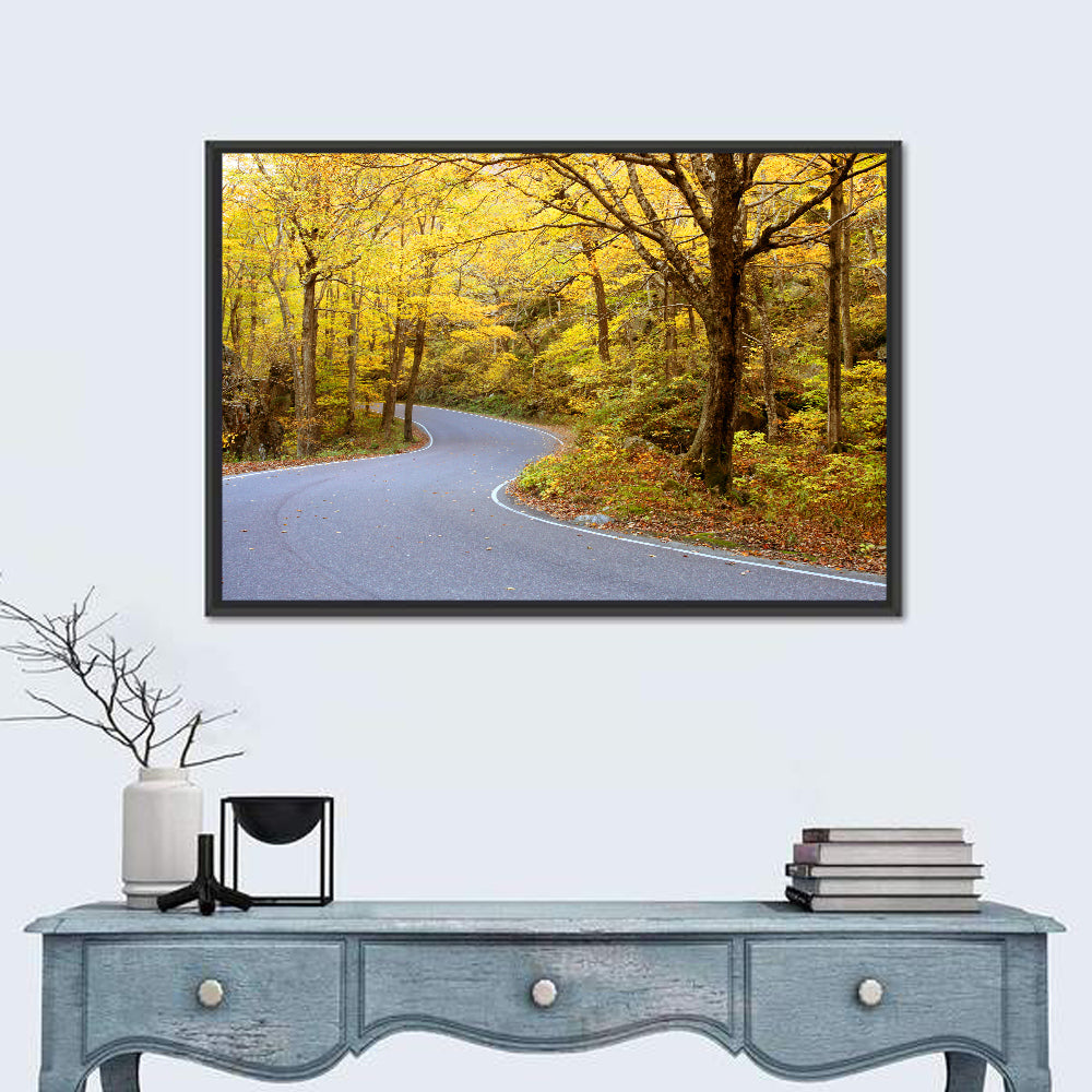 Winding Road Through Autumn Foliage Wall Art in a room, landscape