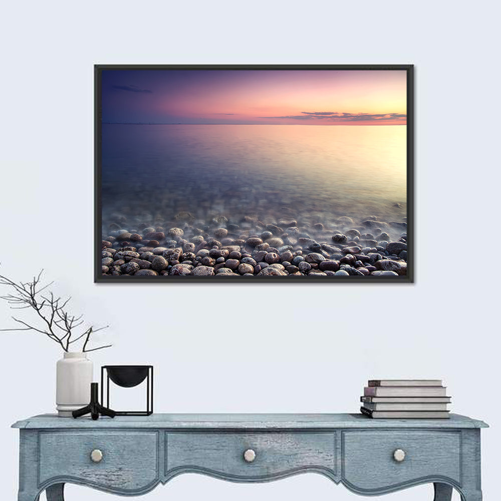 Pebbled Shore Sunset Wall Art in a room, landscape