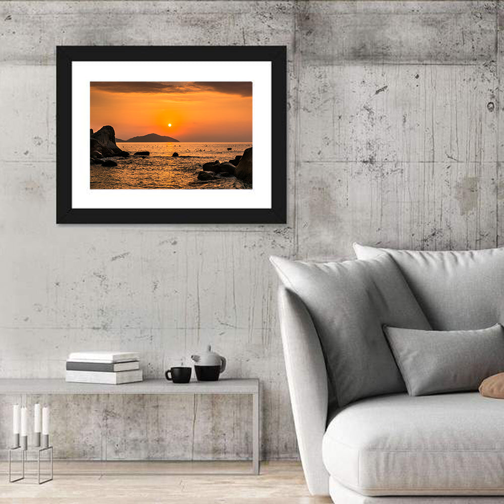 Orange Sunrise Over Rocky Coast Wall Art in a room, landscape