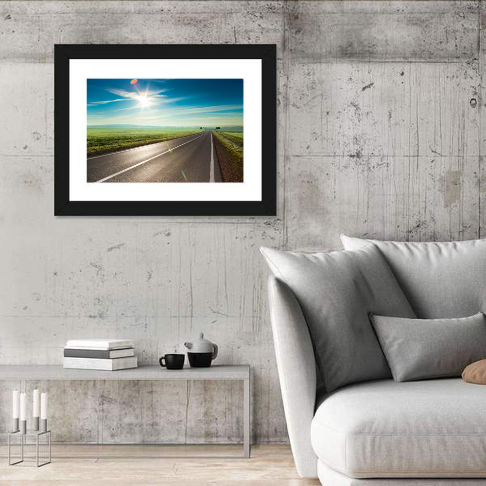 Sunlit Road Through Green Field Wall Art in a room, landscape