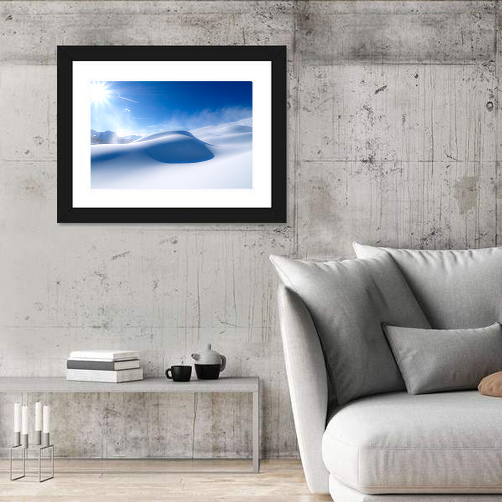 Sunlit Snow Dune Under Blue Sky Wall Art in a room, landscape