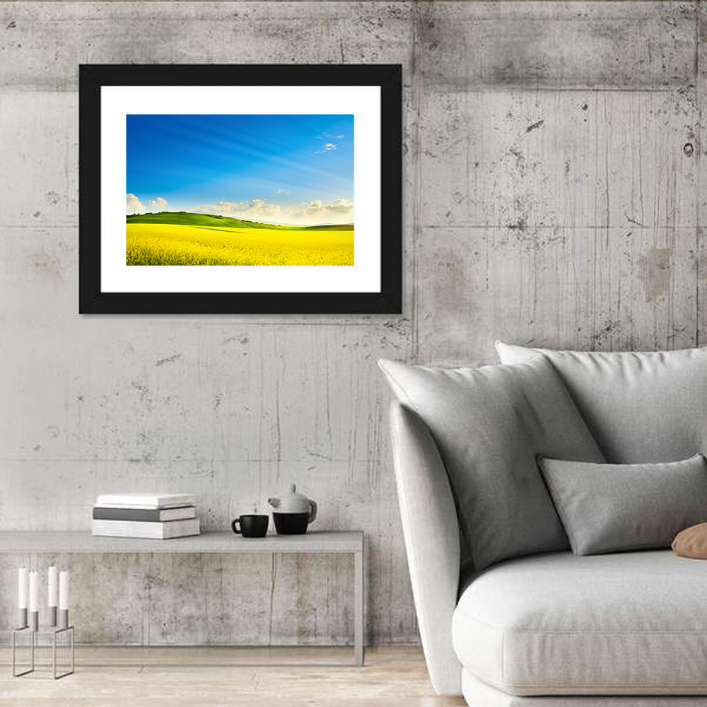 Rapeseed Field and Rolling Hills Under Blue Sky Wall Art in a room, landscape