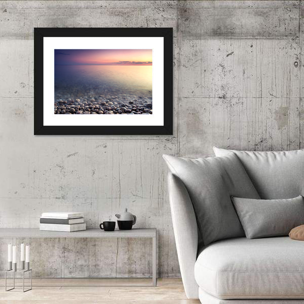 Pebbled Shore Sunset Wall Art in a room, landscape