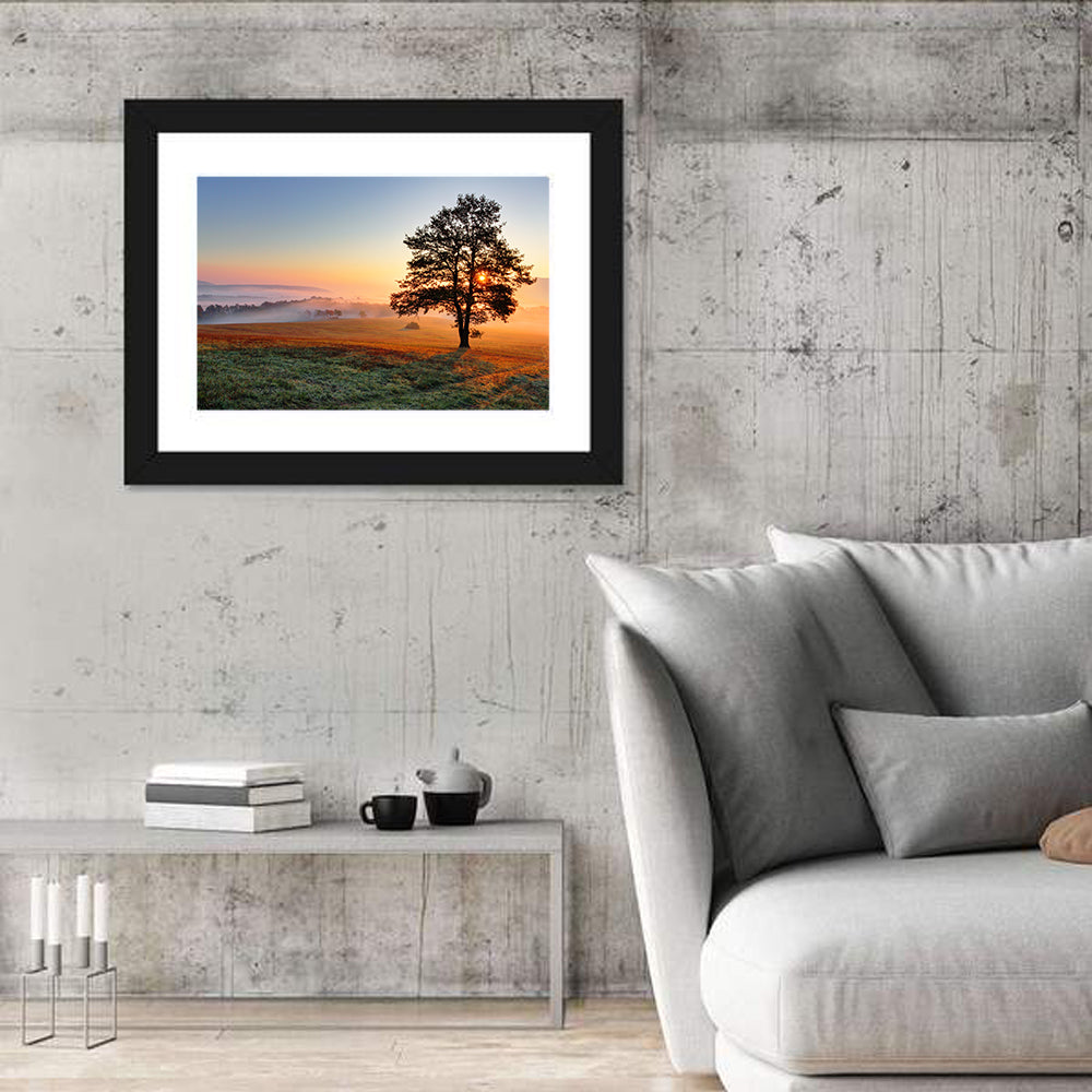 Misty Meadow Sunrise with Lone Tree Wall Art in a room, landscape