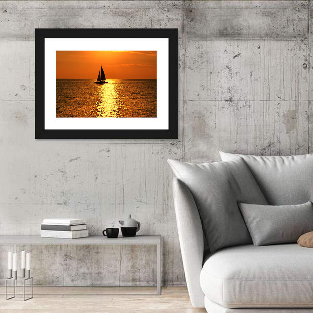 Sailboat Silhouette at Golden Sunset Wall Art in a room, landscape