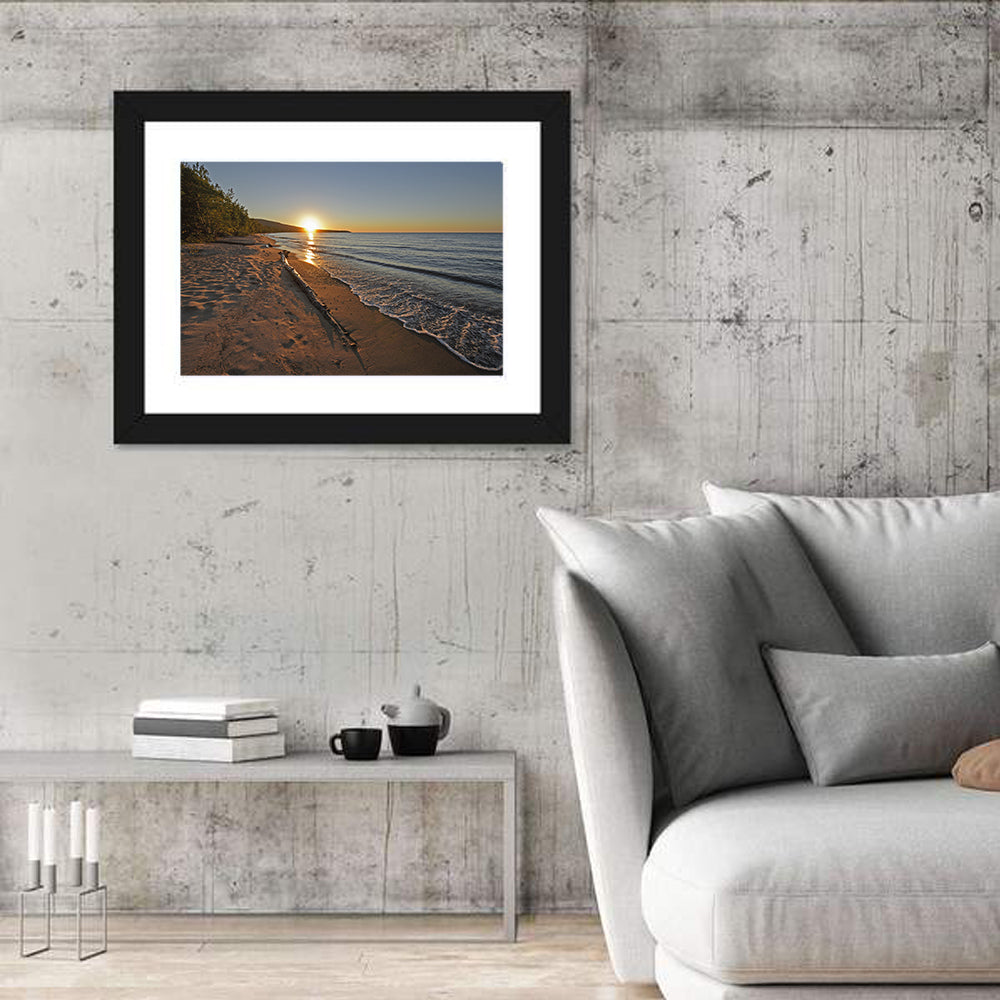 Lake Superior Driftwood Beach Sunset Wall Art in a room, landscape
