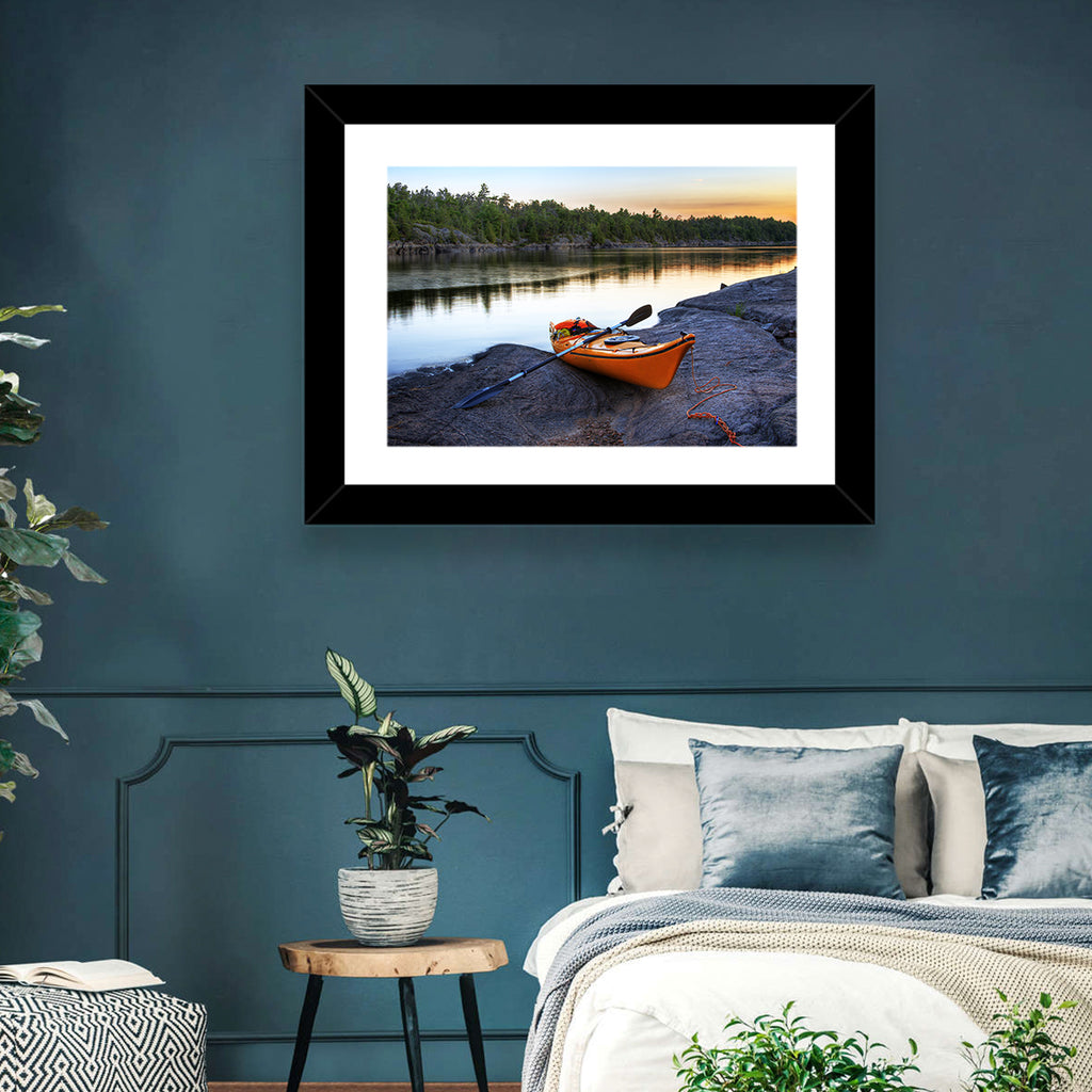 Orange Kayak on Rocky Shore Wall Art
