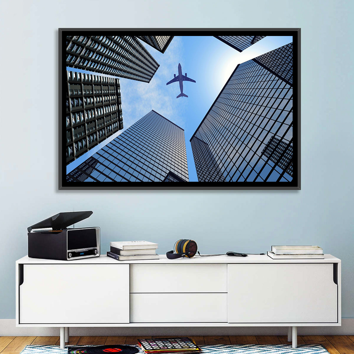 Airplane Above Skyscrapers Wall Art in a room, landscape