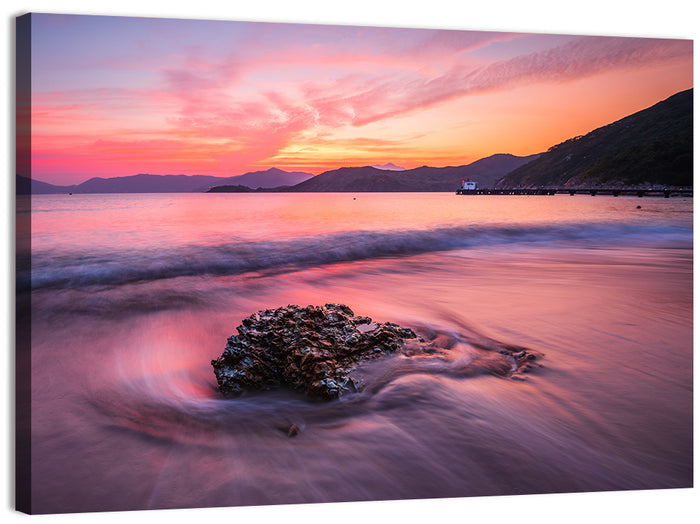Pink Sunset Over Rock and Pier Wall Art as a canvas print