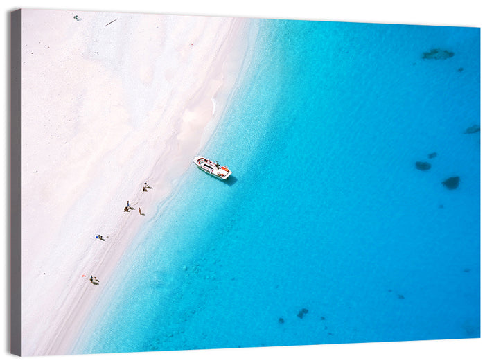 Aerial Beach Bay with White Boat Wall Art as a canvas print