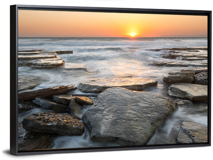 Golden Hour Rock Shoreline Sunset Wall Art as a framed canvas