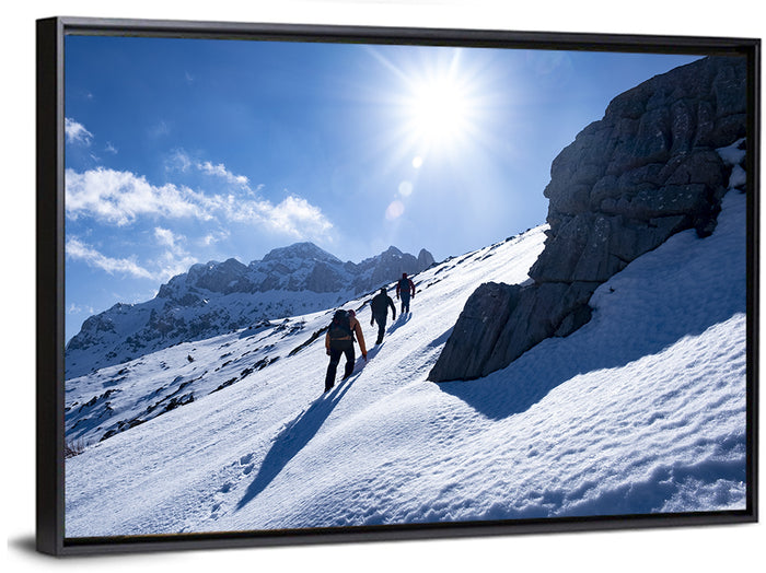 Ascending Mountaineers on Snowy Slope Wall Art as a framed canvas