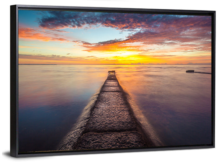 Stone Pier to Glowing Horizon Wall Art as a framed canvas