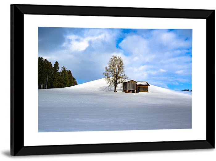 Rustic Barn on a Snowy Hill Wall Art as a framed print