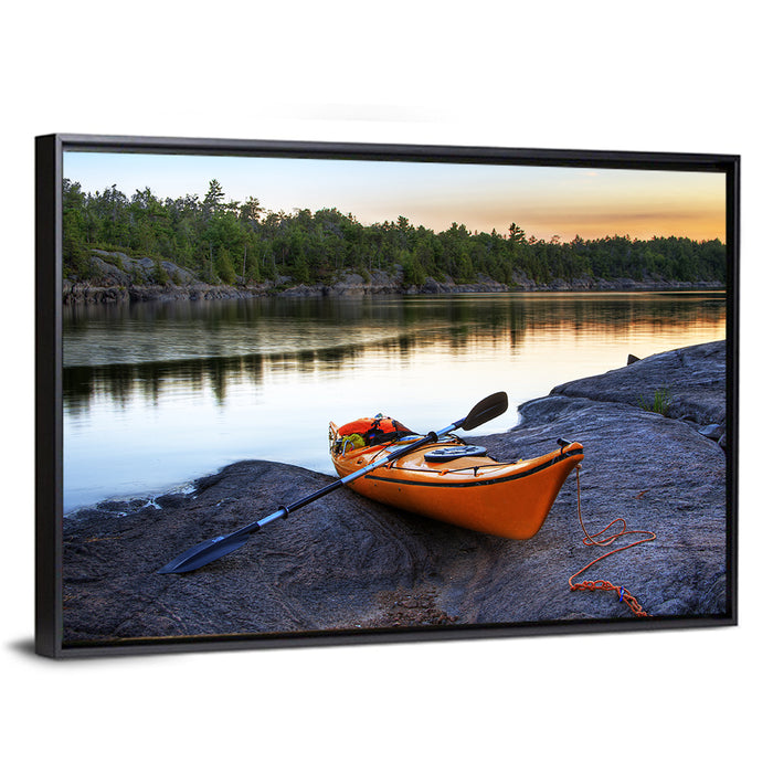 Orange Kayak on Rocky Shore Wall Art as a framed canvas