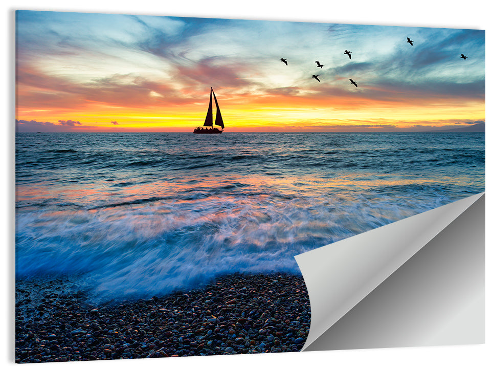 Sunset Sailboat Over Pebble Shore Wall Art