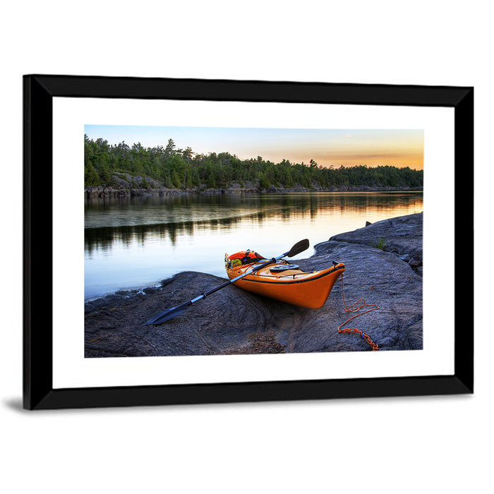 Orange Kayak on Rocky Shore Wall Art as a framed print