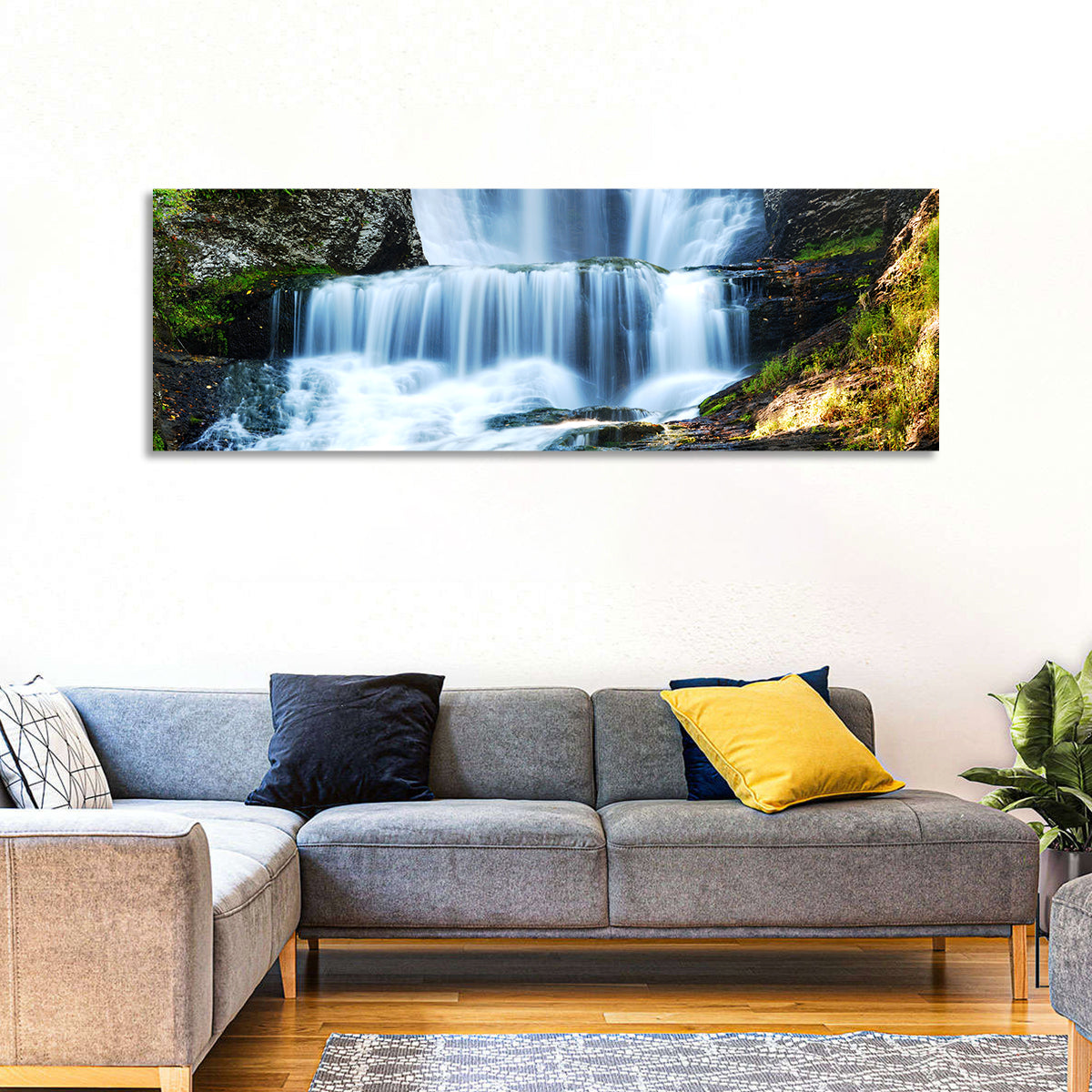 White Waterfall Over Mossy Rocks Wall Art in a room, panoramic