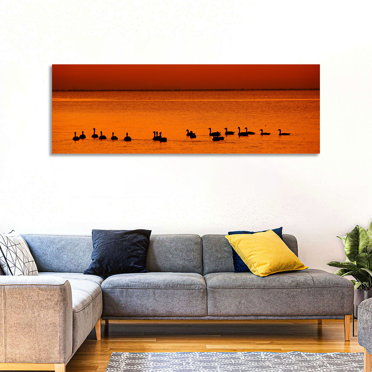 Geese Silhouettes at Orange Sunset Wall Art in a room, panoramic