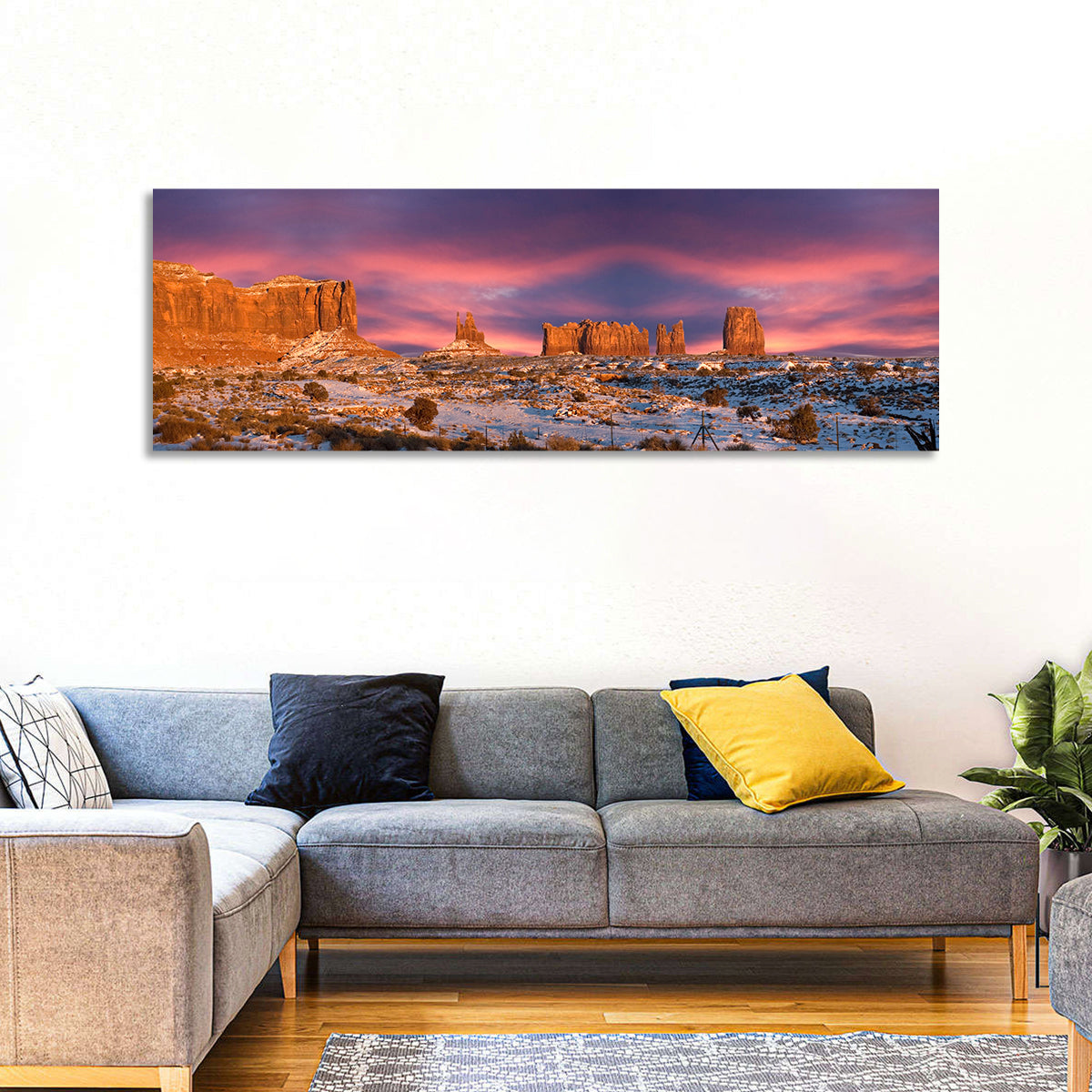 Snow-dusted Monument Valley Sunset Wall Art in a room, panoramic
