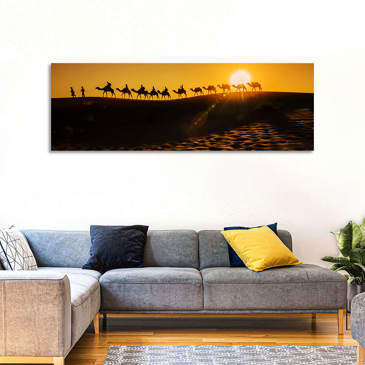 Camel Caravan Silhouette at Golden Sunset Wall Art in a room, panoramic