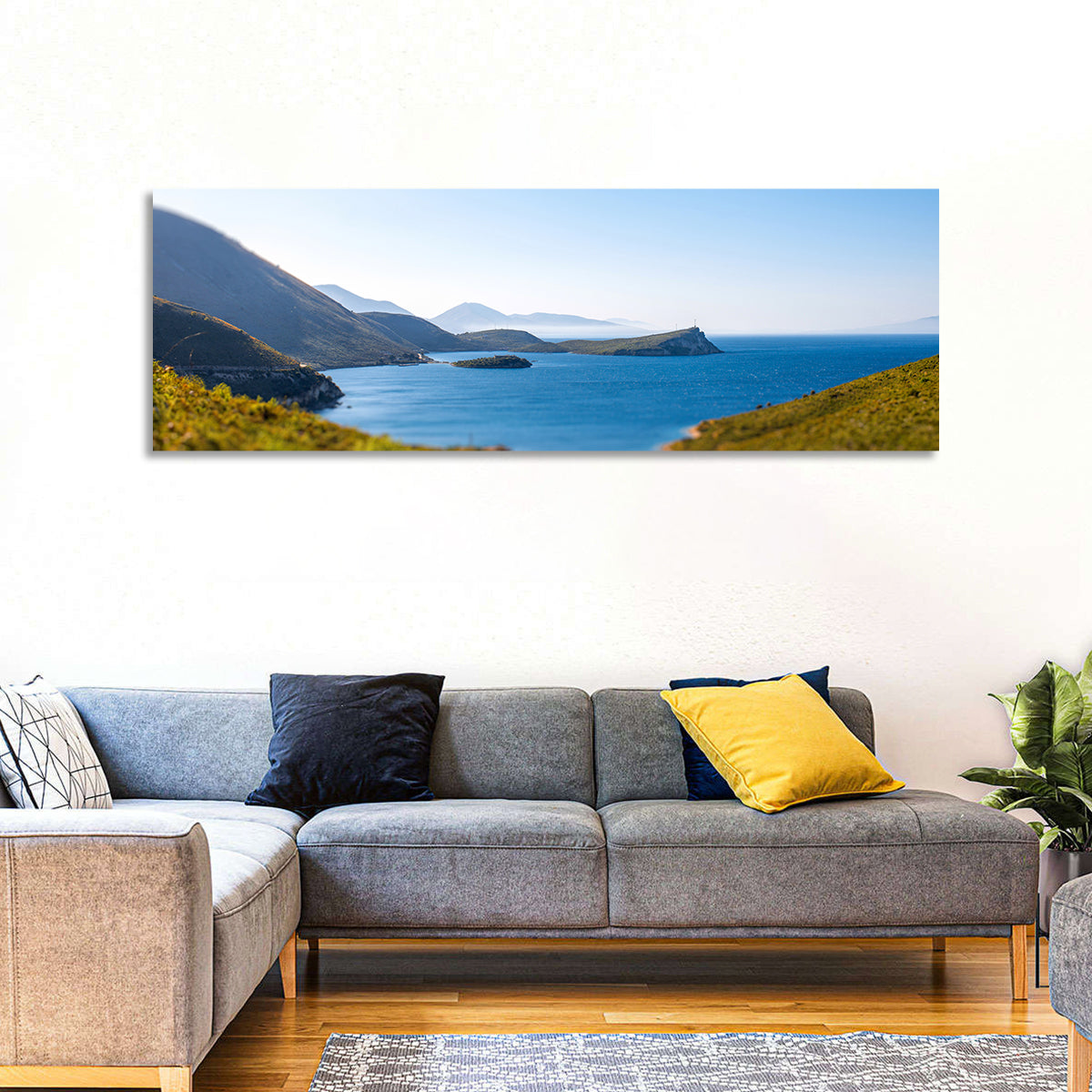 Coastal Cliffs and Lighthouse Bay Wall Art in a room, panoramic