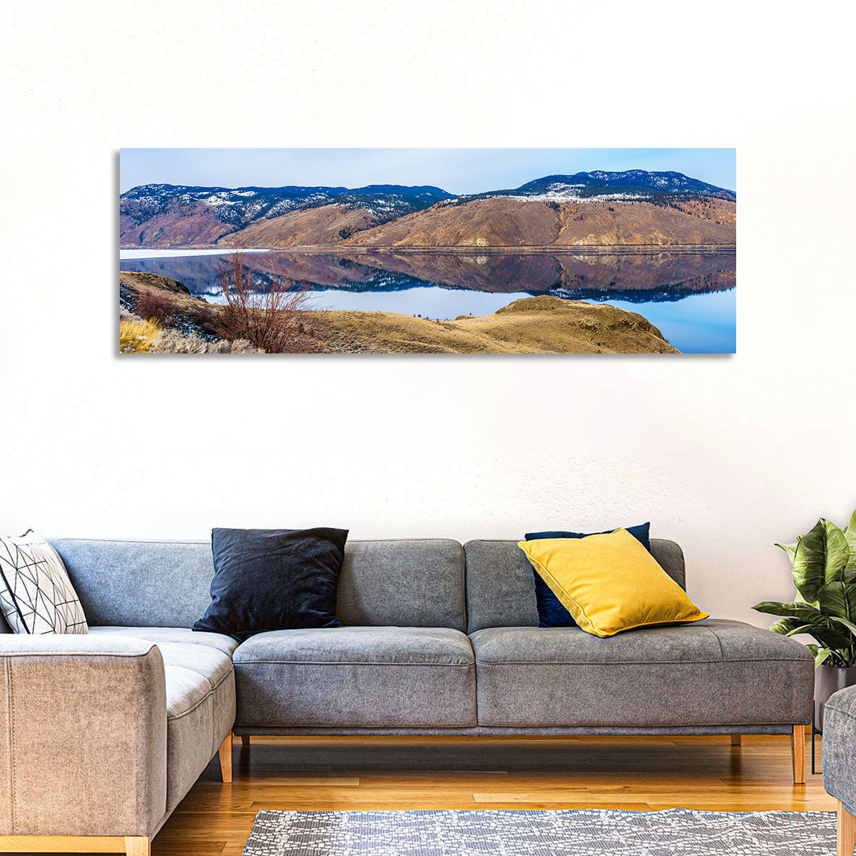 Kamloops Lake Mountain Reflection Wall Art in a room, panoramic