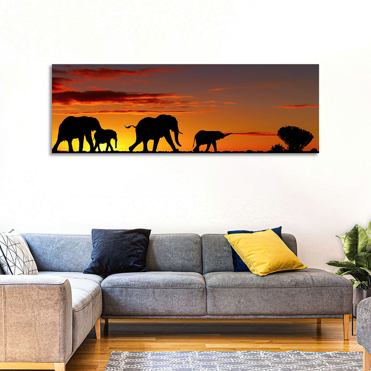 Elephant Herd at Sunset Wall Art in a room, panoramic