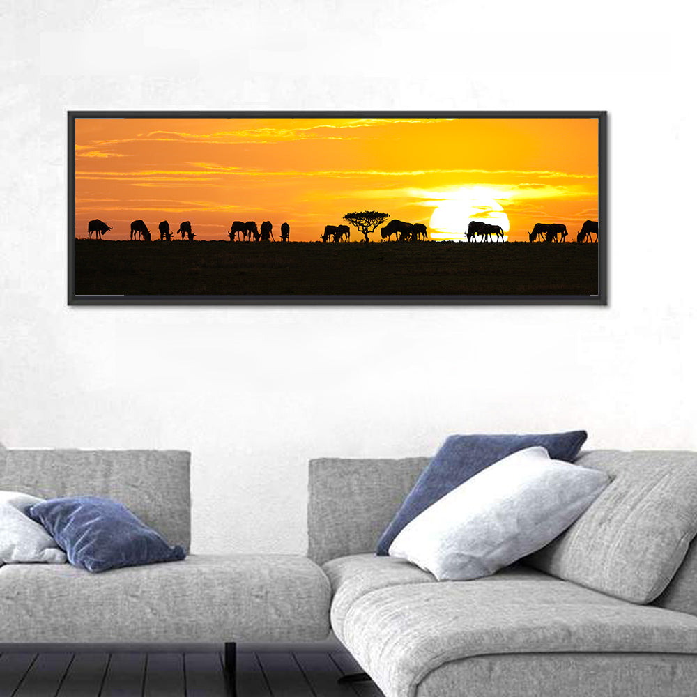 Wildebeest Silhouettes at Sunset Wall Art in a room, panoramic