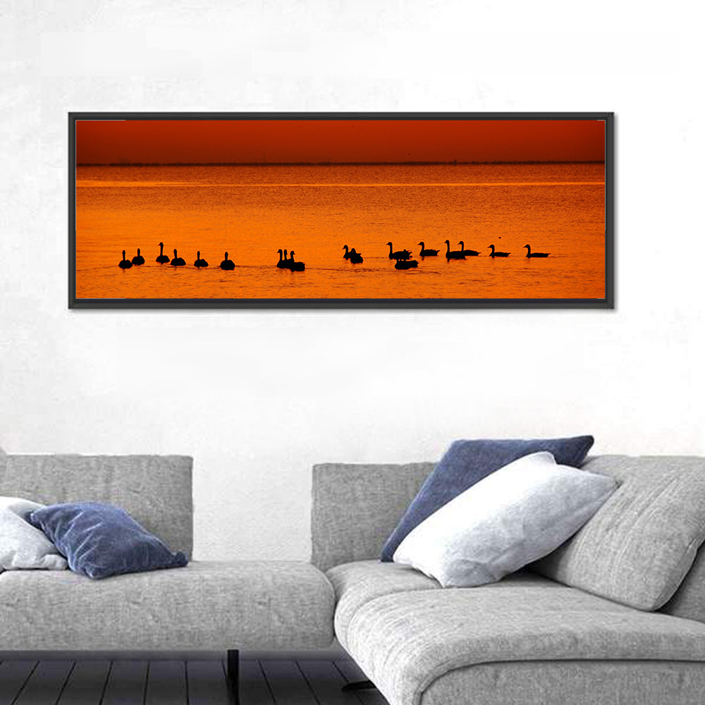 Geese Silhouettes at Orange Sunset Wall Art in a room, panoramic