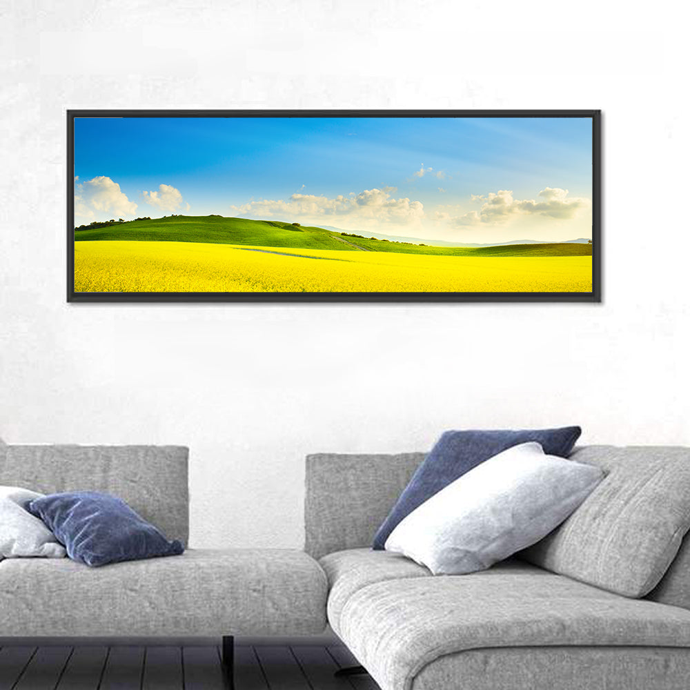Rapeseed Field and Rolling Hills Under Blue Sky Wall Art in a room, panoramic