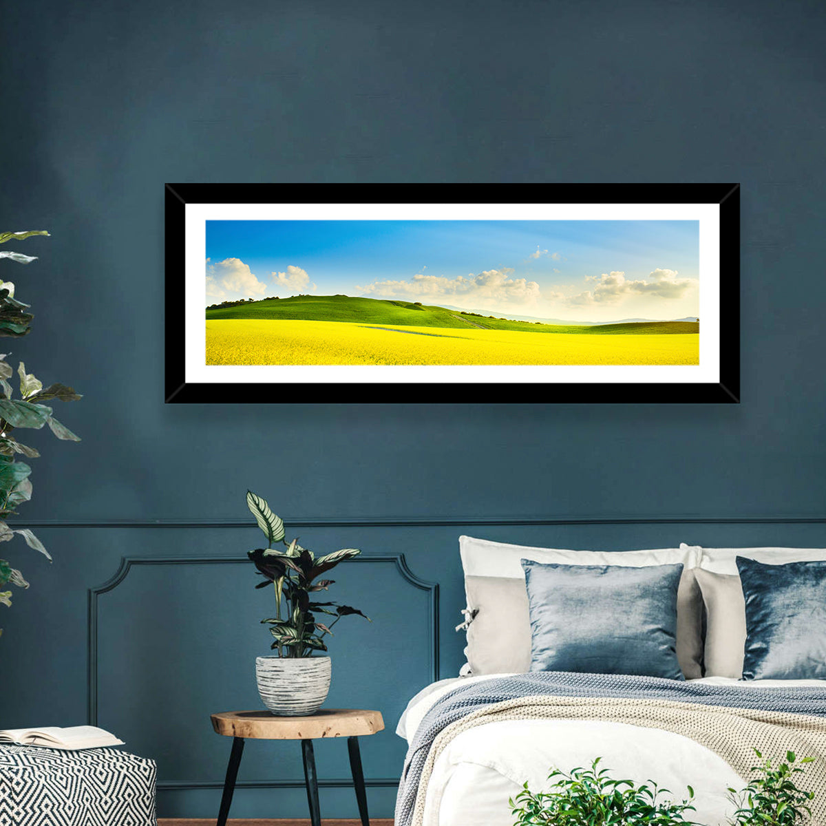 Rapeseed Field and Rolling Hills Under Blue Sky Wall Art in a room, panoramic