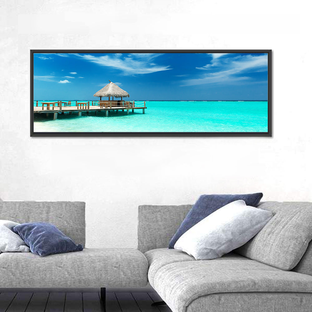 Thatched Beach Bar Pier Wall Art in a room, panoramic