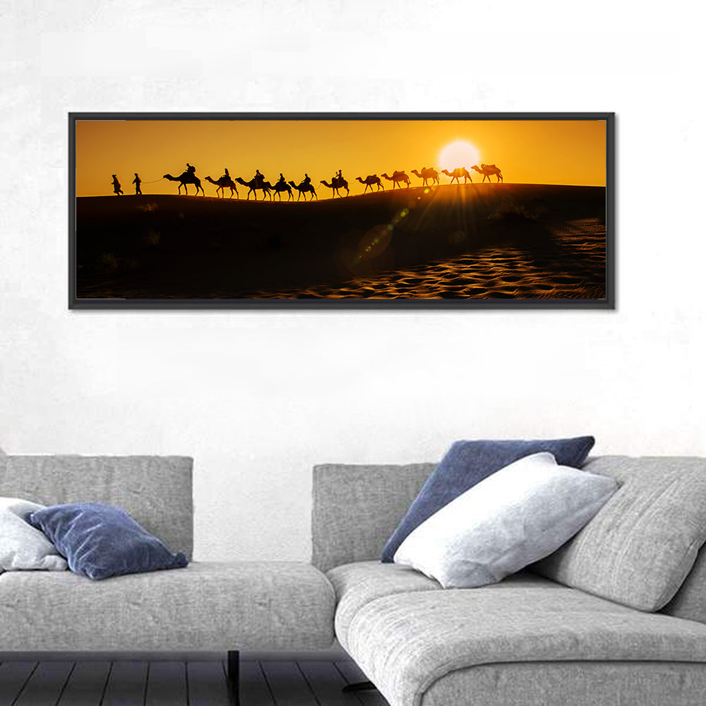 Camel Caravan Silhouette at Golden Sunset Wall Art in a room, panoramic