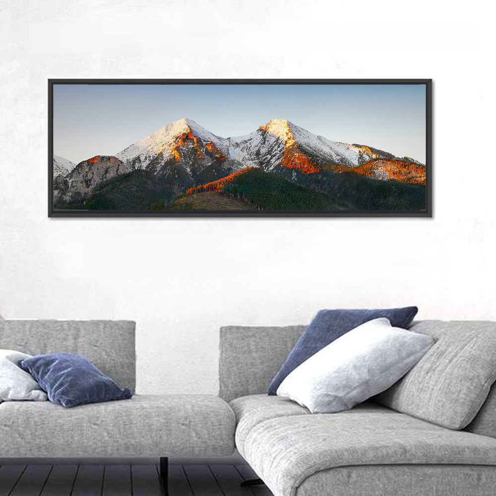 Sunlit Snow Capped Peaks Wall Art in a room, panoramic