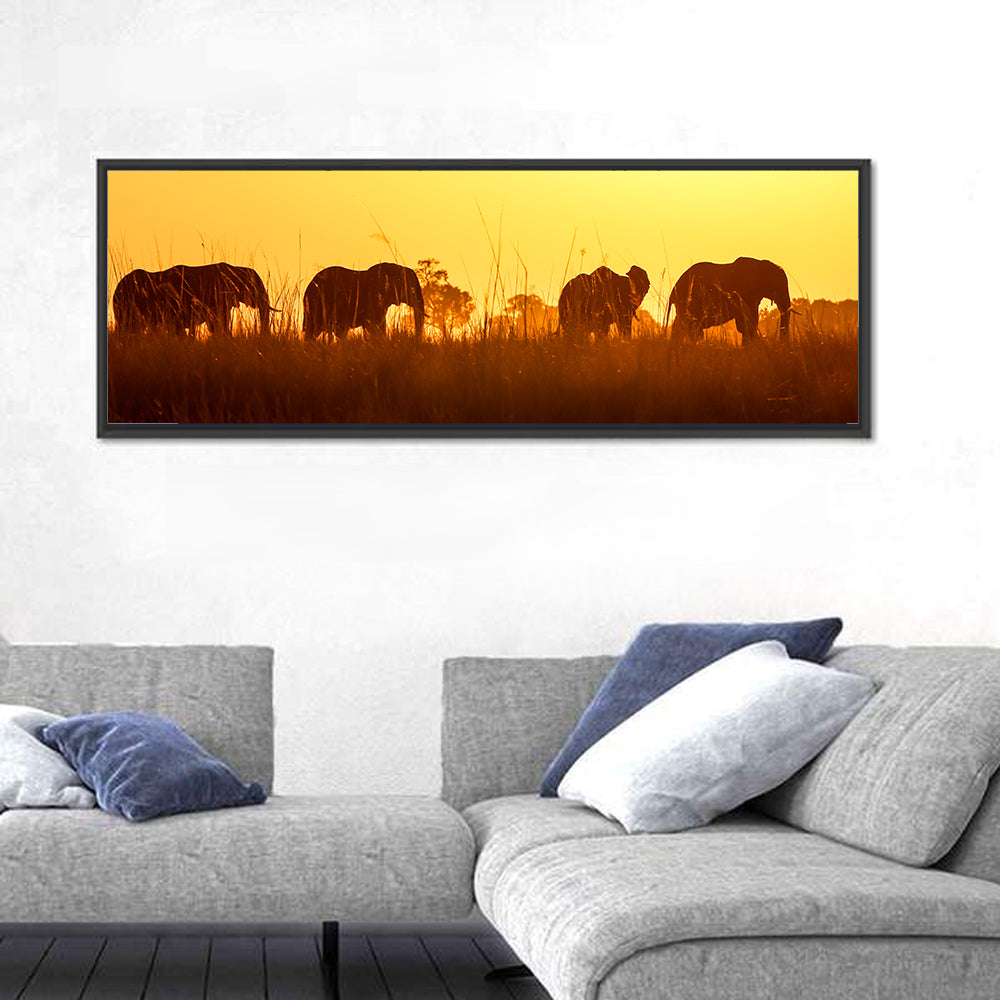 Golden Sunset Elephant Herd Wall Art in a room, panoramic