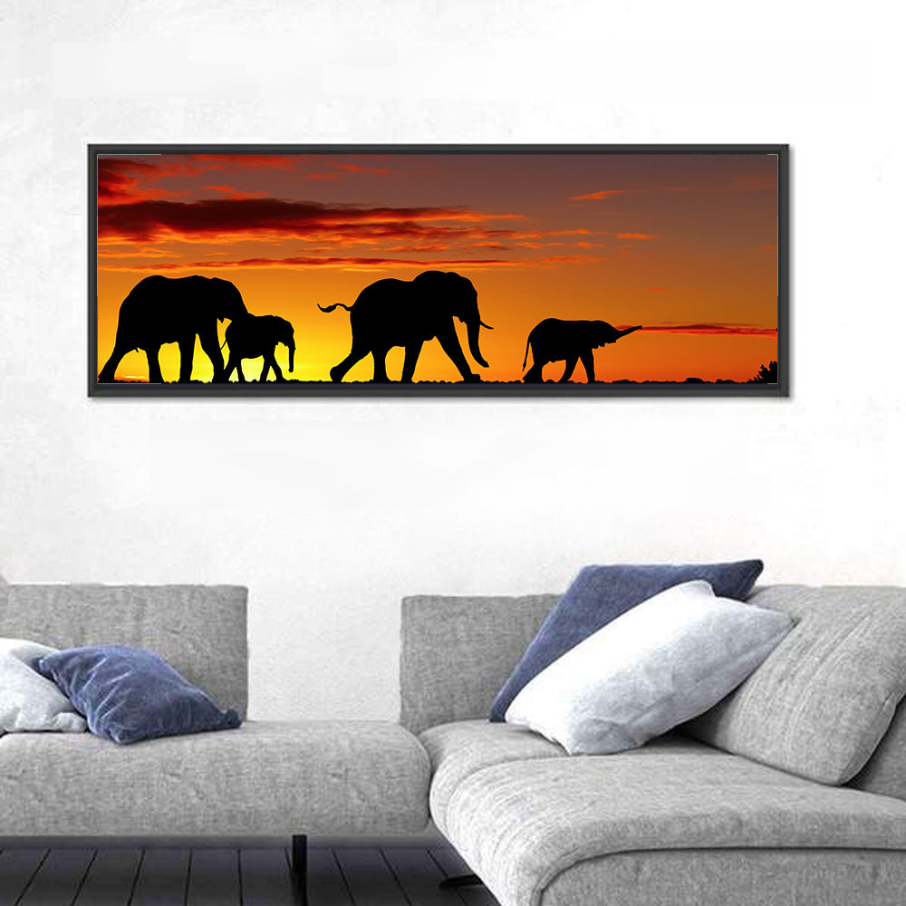 Elephant Herd at Sunset Wall Art in a room, panoramic