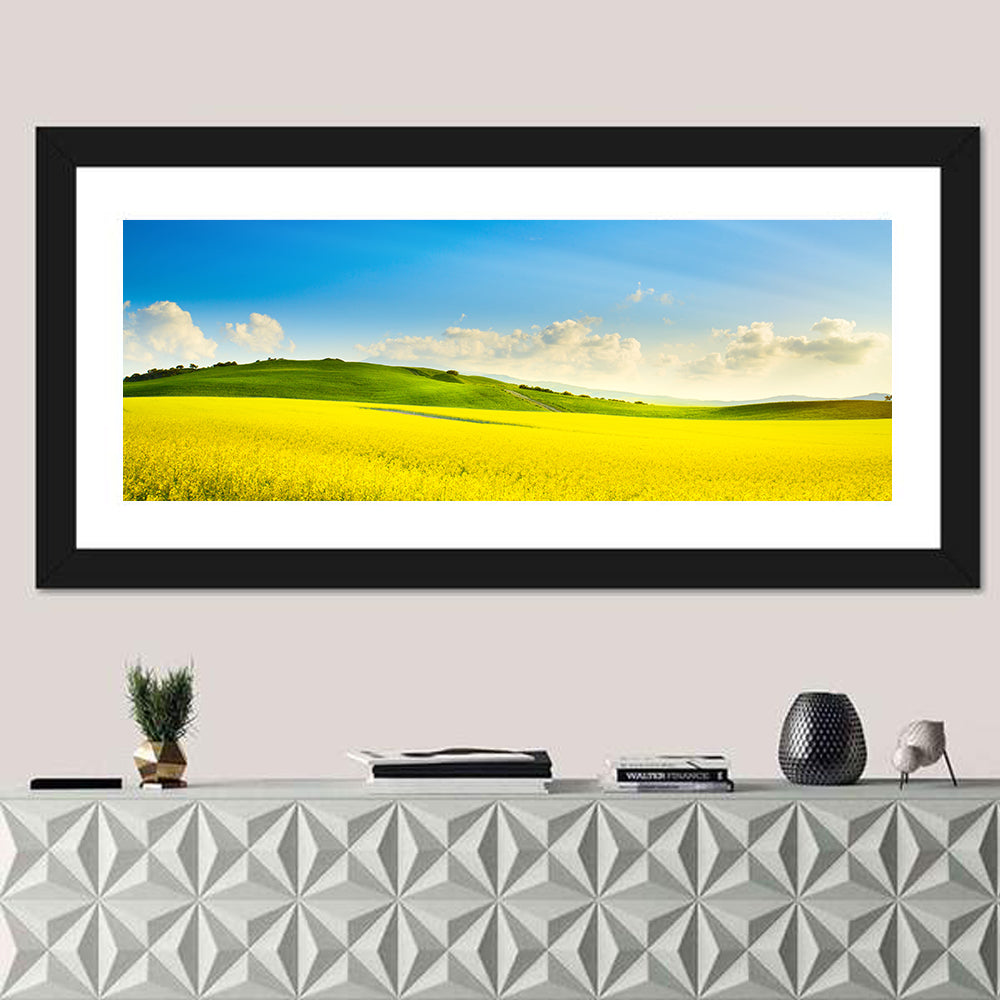 Rapeseed Field and Rolling Hills Under Blue Sky Wall Art in a room, panoramic